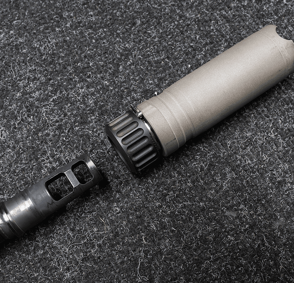Gun suppressor and muzzle brake on fabric.