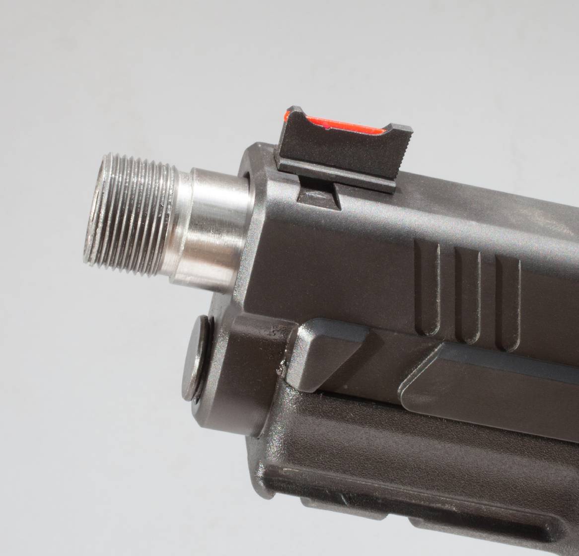 Gun barrel with threaded end visible.