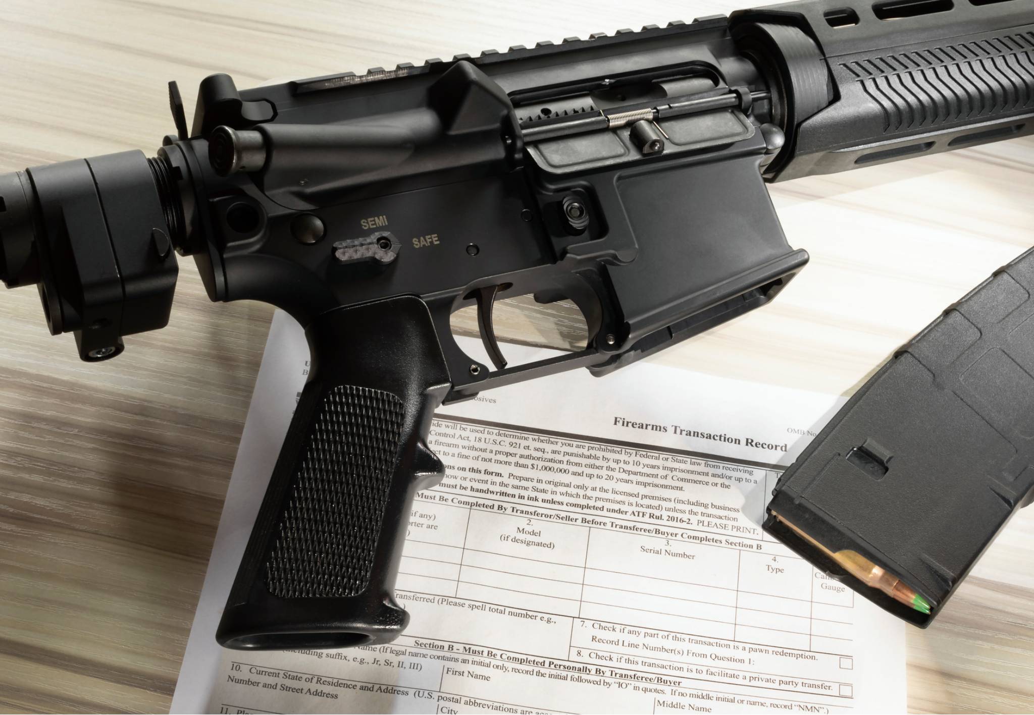 Rifle with magazine and transaction record form.